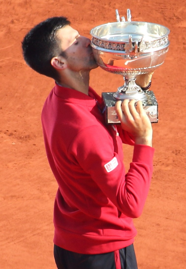 Novak Djokovic aus Serbien hält den French-Open-Pokal und küsst ihn triumphierend nach seinem Sieg gegen Rafael Nadal im Finale der Herren-Einzel.