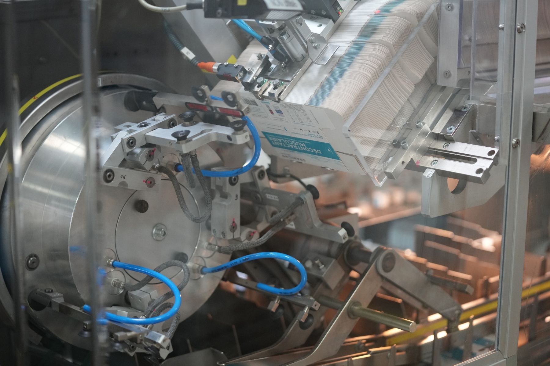 Automatisierte Verpackungssystemmaschine auf einem Fabriktisch mit leicht unscharfen Hintergrundobjekten.